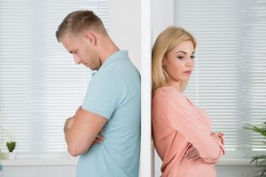 Unhappy Couple Standing Back to Back